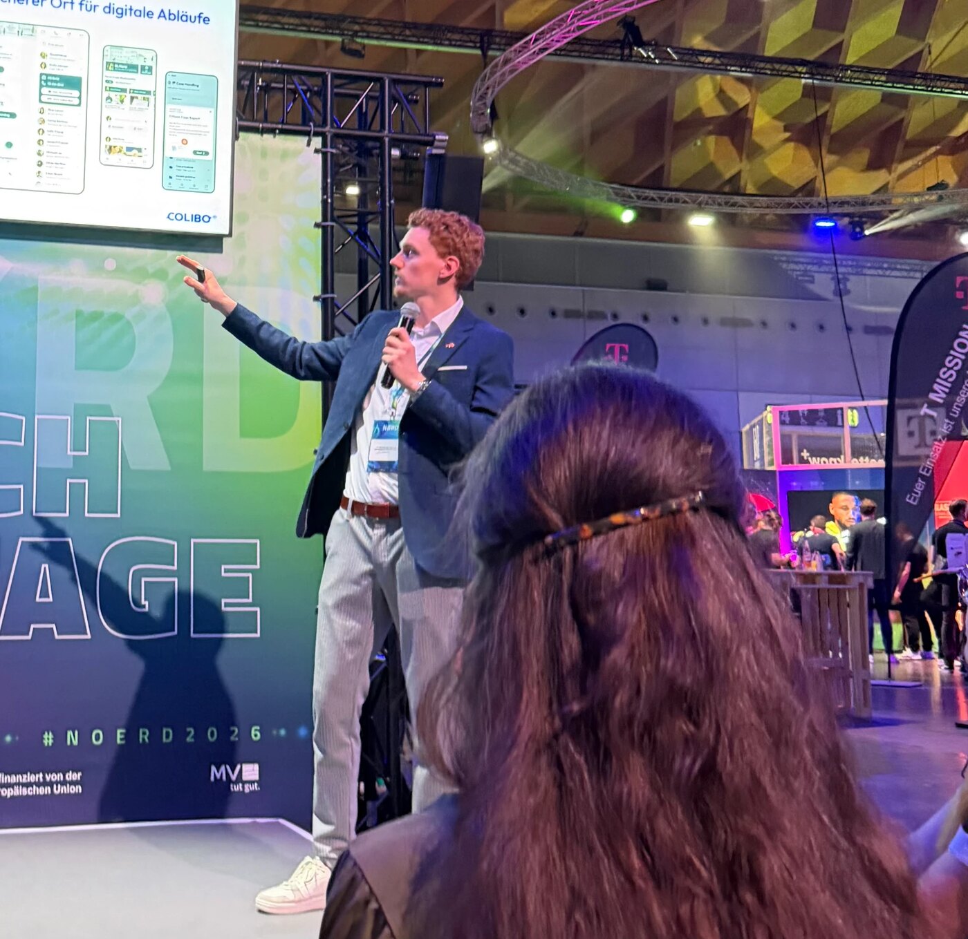 Vincent Stöber speaking on stage at a German tech conference